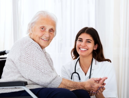 doctor and an elderly woman smiling