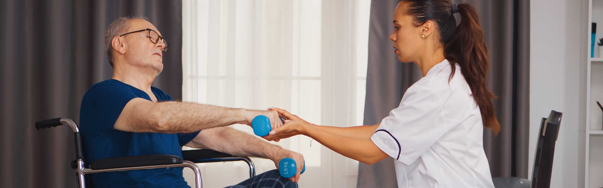 caregiver assisting the elderly man while exercising