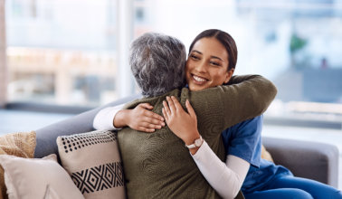 nurse hugging a woman