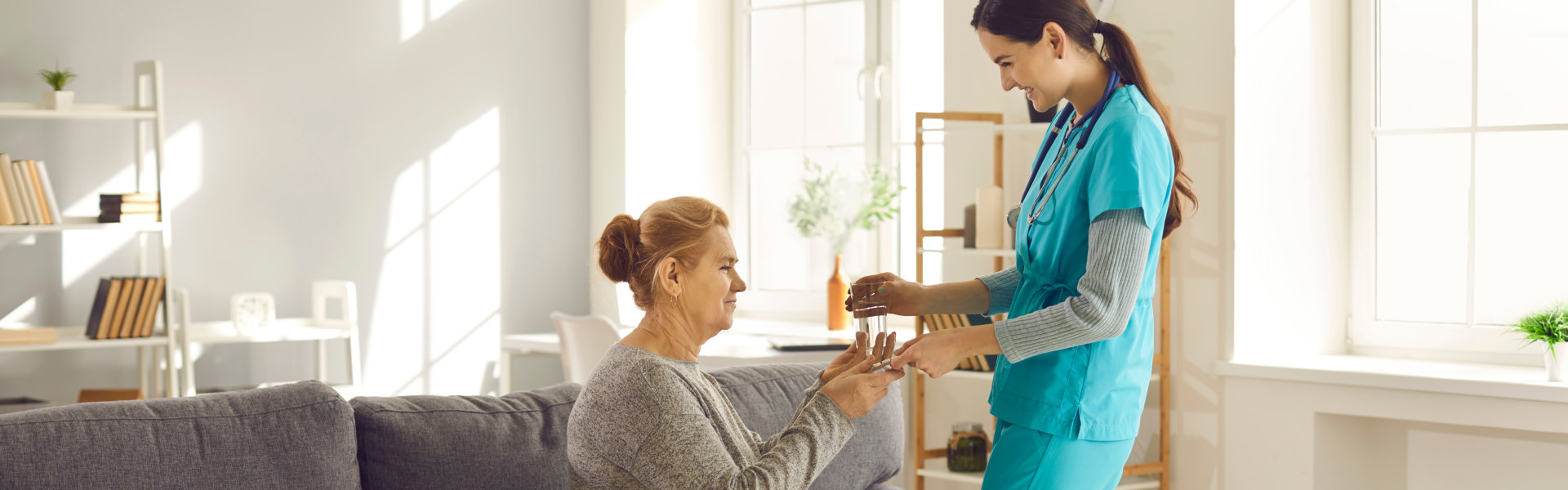 assisted living facility helping woman take medicine